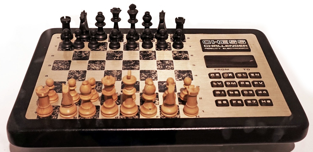 A Fidelity Chess Challenger electronic chess computer with a wooden board.